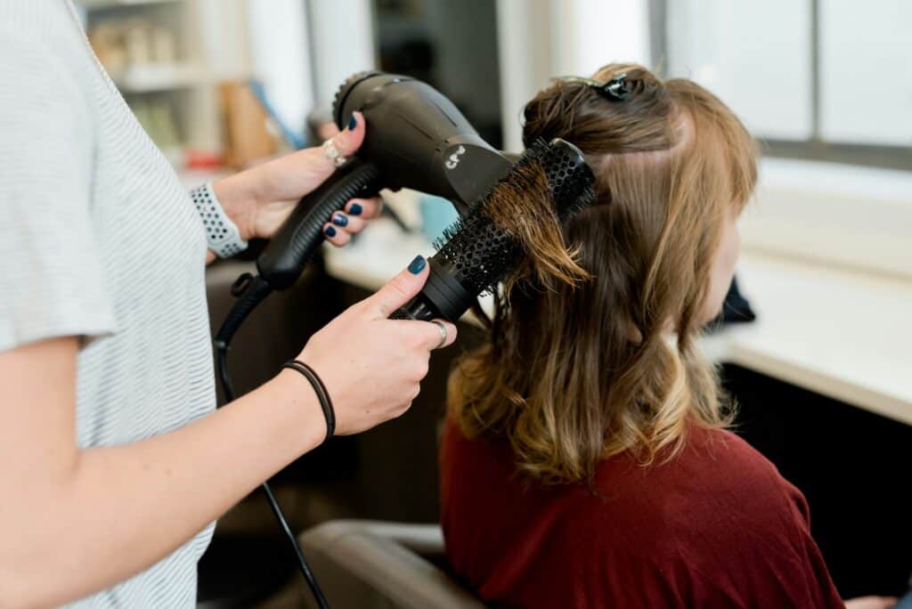 woman holding hair blower